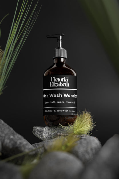 Bottle of 'One Wash Wonder' soap on a rock with plants in the background